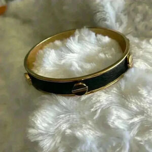 Black and golden bangle bracelet.